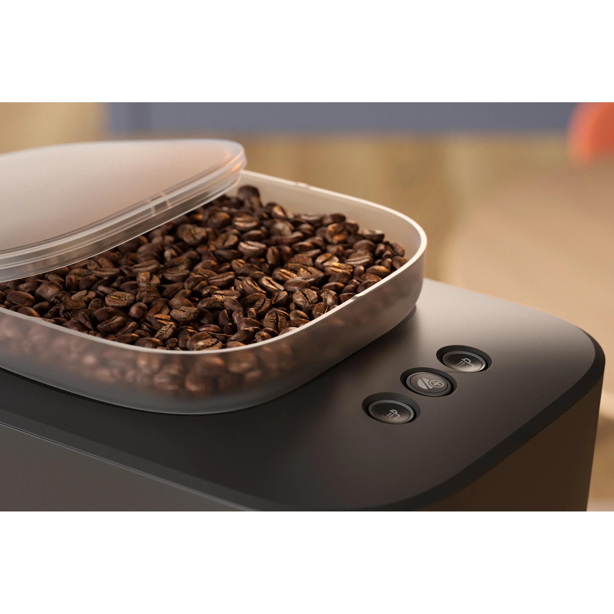 Open bonenbakje van de Philips Baristina vol koffiebonen met drie knoppen ernaast Open bonenbakje van de Philips Baristina vol koffiebonen met drie knoppen ernaast